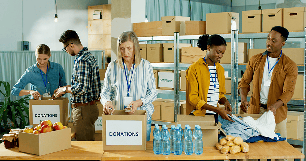 Donations volunteer packing goods at a timebank Ireland charity event.